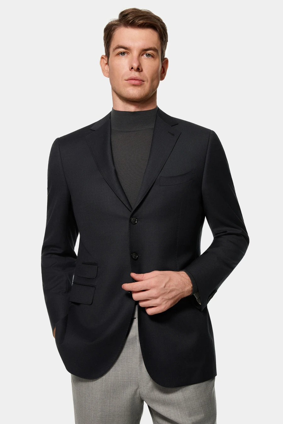 Man wearing a black blazer over a charcoal turtleneck
