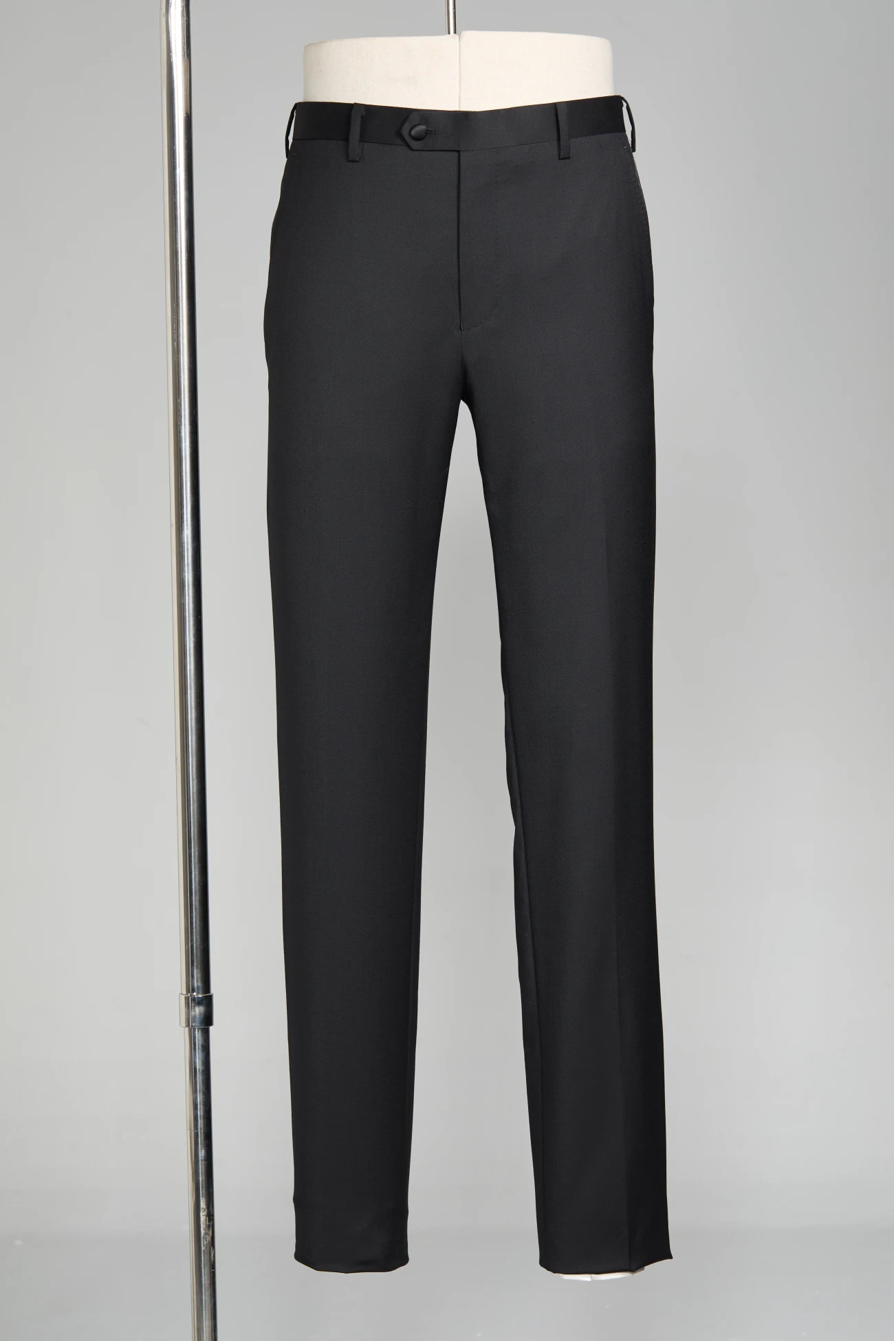 Black tuxedo trousers with a satin side stripe and patent shoes