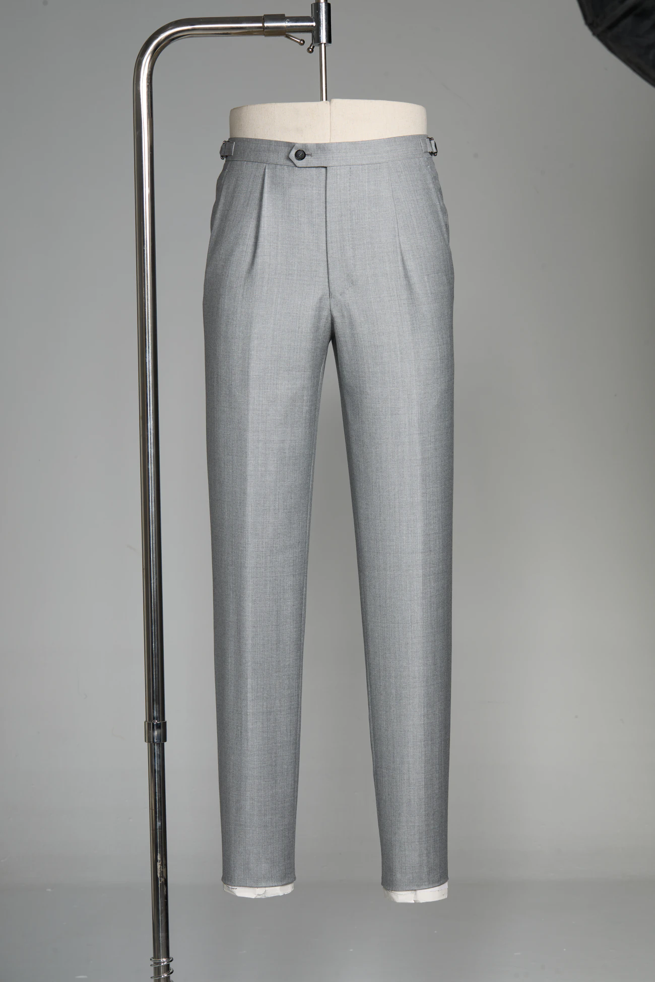 Taupe tailored casual trousers styled with knitwear and loafers
