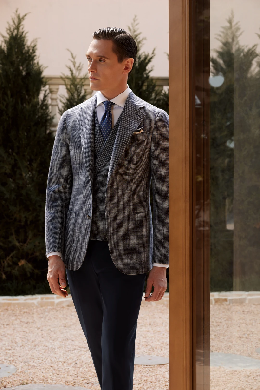 Man wearing a navy blazer in a business setting