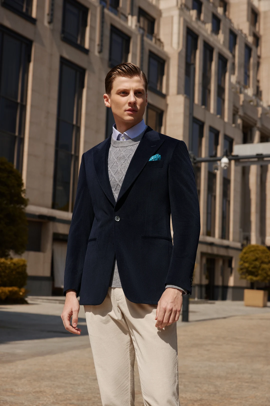 Man wearing a blue sport coat with a knit polo and denim