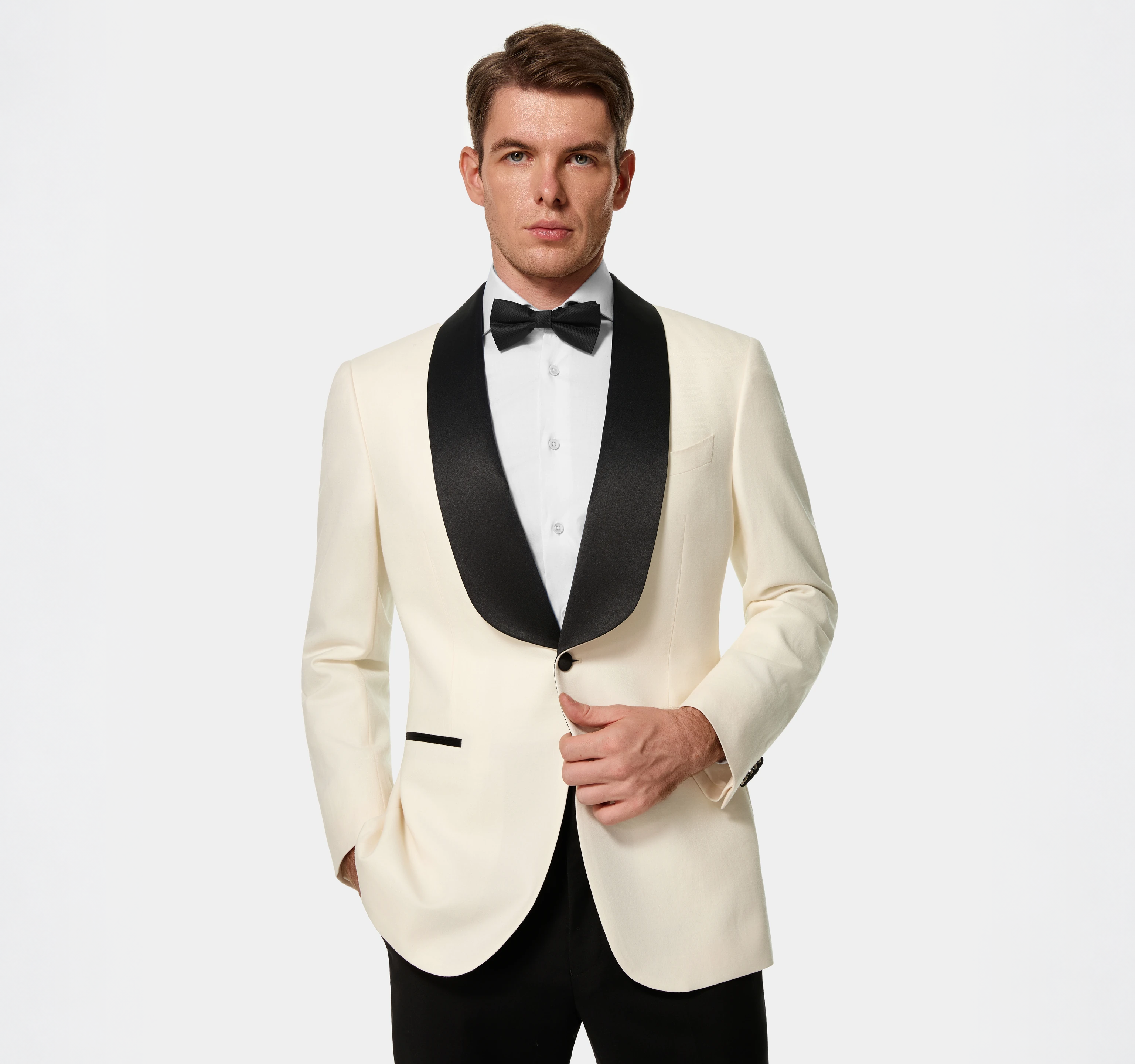 A groom and tailoring consultant selecting wedding-suit fabrics together