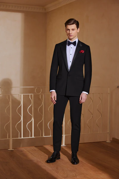 Black tuxedo with satin shawl lapels and a black bow tie