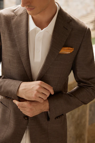 Brown herringbone sport jacket on a wooden hanger
