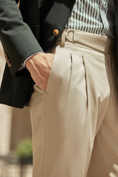 Charcoal wool trousers with a crisp crease and tailored waistband